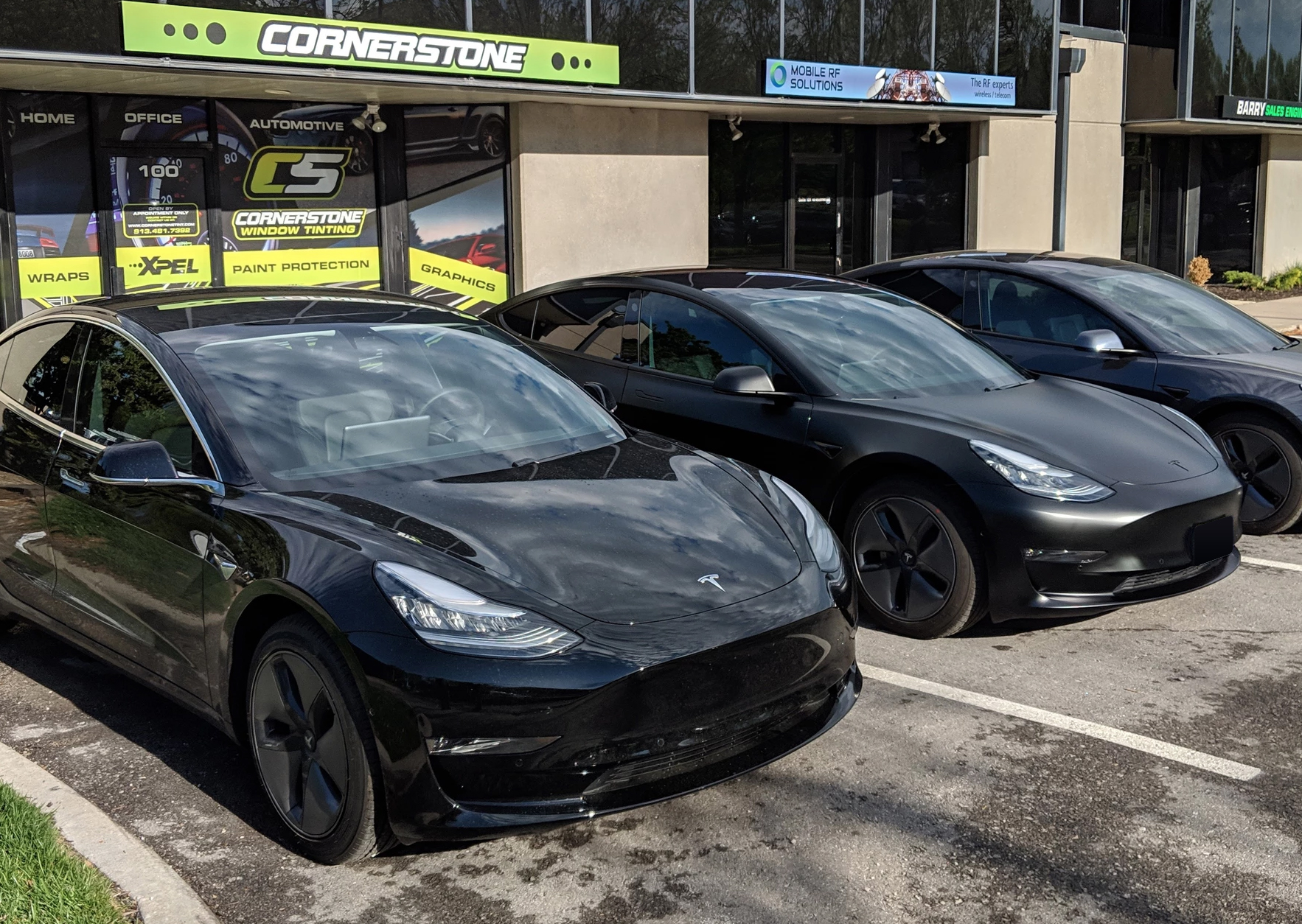 black teslas parked in front of Cornerstone