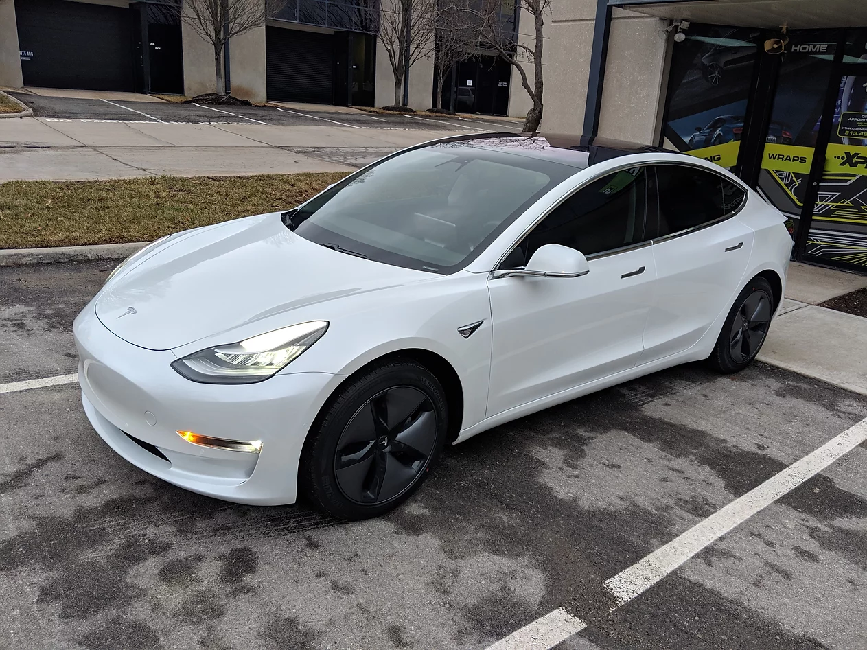 white tesla with tinted windows